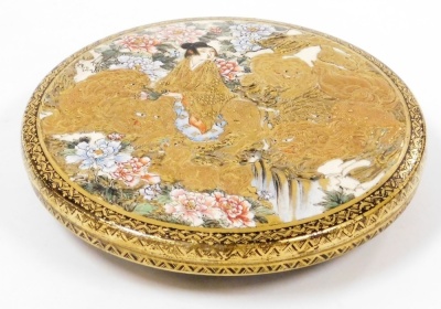 A Meiji period Satsuma kogo and cover, the lid decorated with a figure on horseback among shishi beside a waterfall and flowering branches, the reverse of the lid decorated with a basket of flowers and the interior decorated with figures in procession, fo