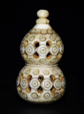 A bone Japanese carved and pierced double gourd netsuke, with screw top, the body with repeated circular incised designs, probably 19thC, 5cm high.