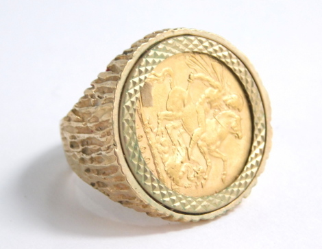 A Victorian gold full sovereign ring, in a textured 9ct gold setting, size V, 18g all in.