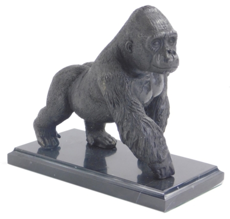 A 20thC bronze figure of a gorilla, on a marble finish plinth base, unsigned, 20cm high.