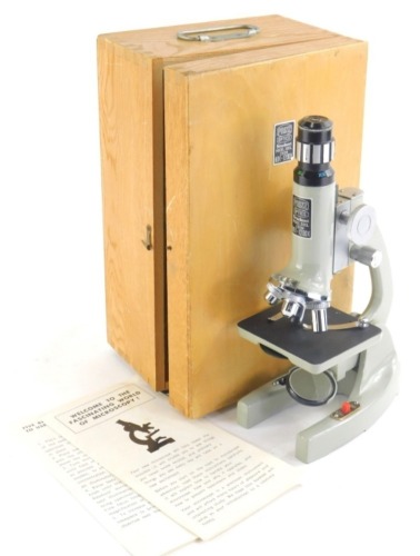 A Prinz Optics student microscope, model 300L 80x x 1200x in box, with paperwork, 25m high.