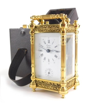 Rapport London. A gilt brass carriage clock with 5cm wide plate with Roman numeric and Arabic dial and subsidiary Arabic second hand, with turned columns and blind fret decoration in a five part glass case with key wind barrel movement, in fitted leather