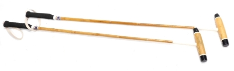 A pair of polo mallets, from the collection of esteemed player Jerry Shaw, head of the Chimi Churis polo team, numbered 53 and stamped Tacos Top, with turned grips, 143cm long. (2)