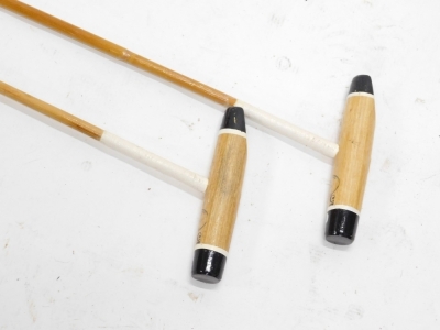 A pair of polo mallets, from the collection of esteemed player Jerry Shaw, head of the Chimi Churis polo team, numbered 53 and stamped Tacos Top, with turned grips, 143cm long. (2) - 2