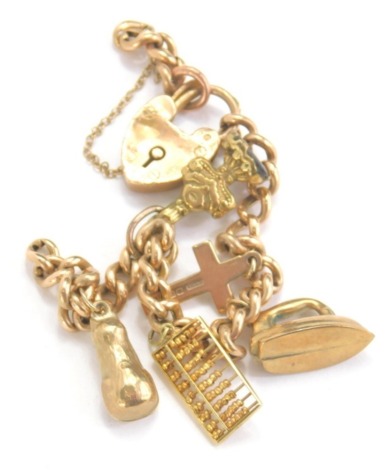 A 9ct gold charm bracelet, with heart shaped clasp and a number of charms to include cross, 2cm high, 14g all in.