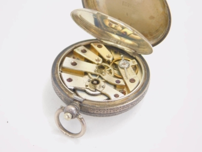 An early 20thC continental ladies fob watch, with fancy 3cm dia. Roman numeric dial in a chased case, white metal marked 0.935. - 2