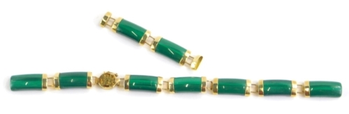 A ladies yellow metal and jade coloured bracelet, with shaped sections, the clasp with Chinese lettering and marked 14k 585, 13cm long and two extra links, 11.3g all in.