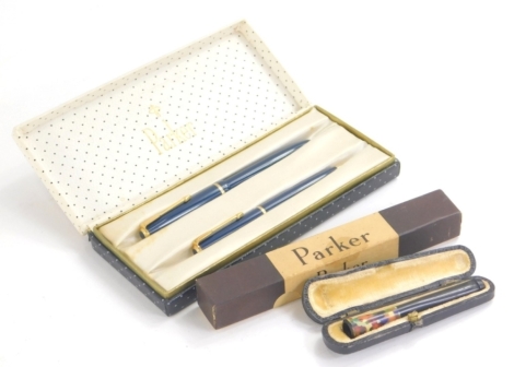 A Parker fountain pen and ball point pen set, in blue with gilt coloured trim, and arrow clip, the fountain pen with fourteen K nib, 12cm long, a further Parker fountain pen with fourteen pen nibs and a cased cigarette holder. (a quantity)