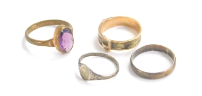 A 9ct gold memorial buckle ring, size L, dress ring set with oval purple and two further rings. (4)