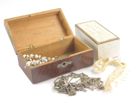 A small quantity of various costume jewellery, necklaces, flapper style necklace, buckle ring, etc., contained in a wooden box, 15cm wide.