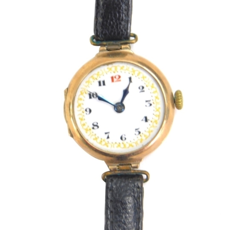 A 9ct gold cased wristwatch, with fancy enamel dial, Arabic numerals and leather strap, 19g all in.