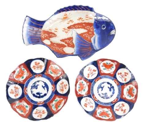 An Imari pattern fish dish, 32cm wide, and two similar plates with floral borders. (3)