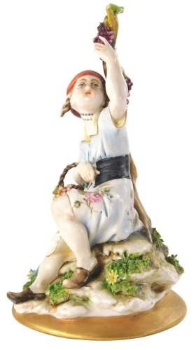 A Capodimonte figure group of a child beside branches, on a naturalistic base, 19cm high.