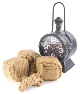 A reproduction quartz ship style clock, with shaped handle, 43cm high, and various entwined rope.
