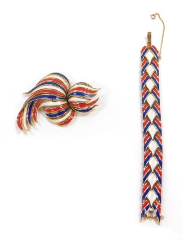 Two items of Trifari costume jewellery, each in red, blue and white enamel detailing, comprising a bracelet with safety chain, 17.5cm long, and a two tier spray brooch, 8cm x 5cm, both marked Trifari.