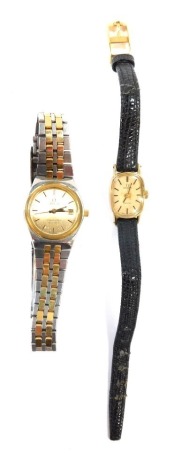 Two Omega ladies wristwatches, comprising an Omega Seamaster, in stainless steel case, with bi-colour strap, date aperture numbered 1380, the dial 2cm wide, and an Omega plated stainless steel backed Geneva wristwatch, the dial 1.4cm wide on leather strap