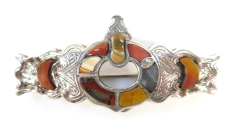 A Scottish agate set brooch, the bar with central buckle design and multicoloured agate set border, of floral scrolling white metal unmarked, 6.5cm wide, 12.8g all in.