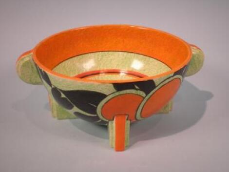 A Clarice Cliff "Mango" pattern bowl on a cafe au lait ground with two