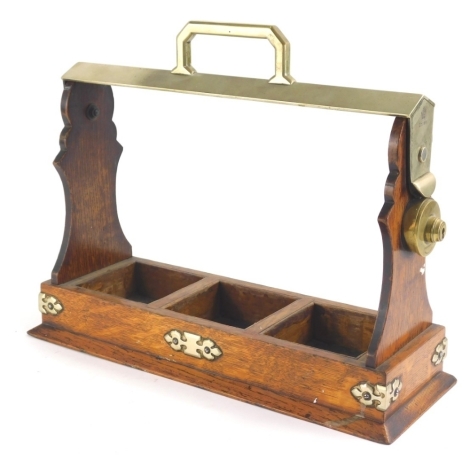 An early 20thC oak cased tantalus case, with metal mounts, stamped with a crown number G7028, 28cm high.
