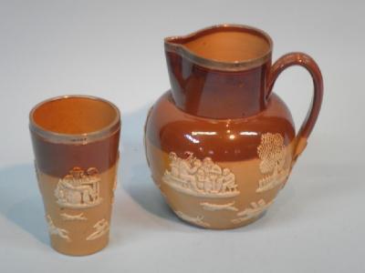 A Doulton Lambeth stoneware jug with a silver mount and a similar