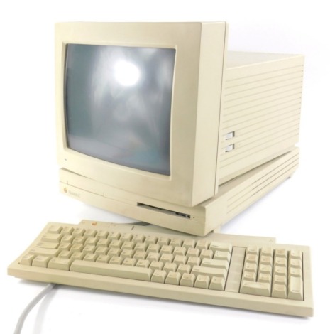 A vintage Macintosh LC home computer, with 29cm wide monitor, keyboard, other wires and accessories. (a quantity)