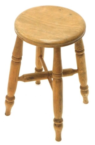 A country made turned ash stool, with a circular seat and an X stretcher, on turned legs, 51cm high, 29cm dia.