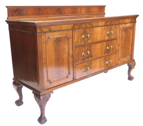 An early 20thC mahogany sideboard, with a raised back, the top with a moulded edge above an arrangement of three drawers, flanked by two panelled doors with brass drop handles, on cabriole legs and ball and claw feet, 168cm wide.