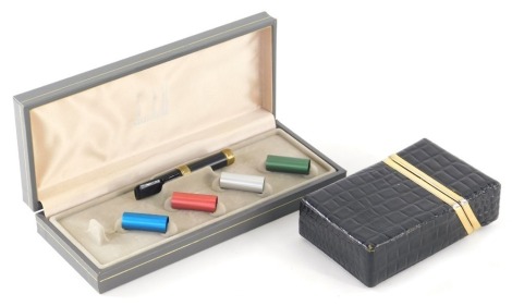 A faux crocodile skin style leather cigarette case, with gilt metal mounts, 18cm wide, and a Dunhill cigarette holder set.