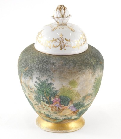 A 20thC Sitzendorf vase, with gilt highlighted domed lid and shouldered circular body, decorated with a country scene with figures before houses on circular foot, double line marks beneath, 33cm high.