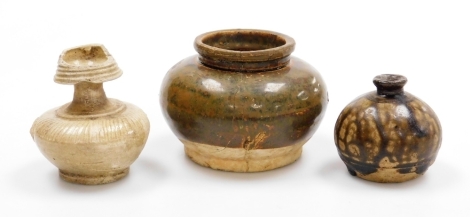A Korean ovoid stoneware vase, with trailing treacle glaze, 6.5cm high, a small incised stoneware bottle vase, 8.6cm high, and a compressed spherical jar, 8cm high, (3).
