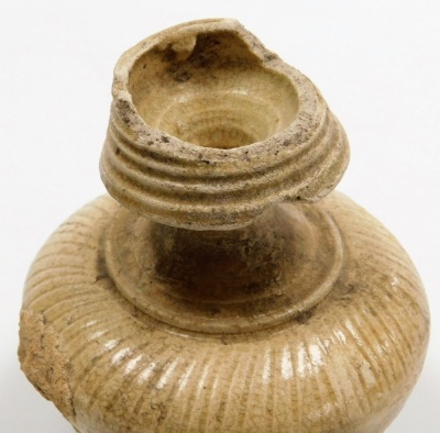 A Korean ovoid stoneware vase, with trailing treacle glaze, 6.5cm high, a small incised stoneware bottle vase, 8.6cm high, and a compressed spherical jar, 8cm high, (3). - 8