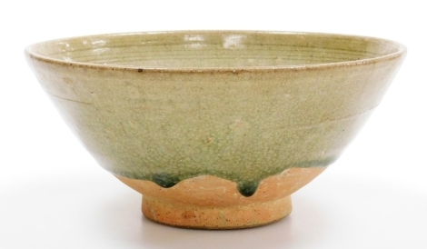 A 20thC Korean stoneware bowl, with partial green crackle glaze over incised decoration to the interior, 20.9 cm high.