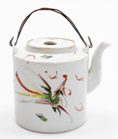 An early 20thC Chinese cylindrical teapot, with hand painted dragon and phoenix decoration, with inset lid and wire handle, 14cm high.