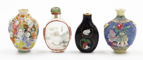 Two Chinese porcelain relief decorated snuff bottles, with Qianlong marks (AF), 7.5cm high, together with a glass snuff bottle, the interior painted with a duck, etc., and a cloisonne bottle decorated with cats, (4).
