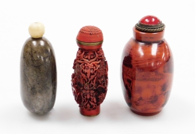 A Chinese hardstone snuff bottle of pebble form and two others, including a faux Cinnabar bottle and a glass faux realgar snuff bottle, 6.2cm high, 6cm high and 6.8cm high respectively, (3). - 4