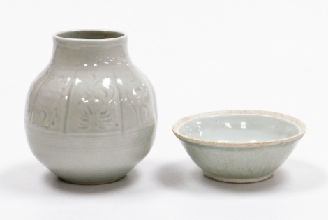 A Korean squat ovoid vase, with panelled incised decoration, signed, 14.5cm high, and a celadon bowl with moulded decoration, 13.5cm high, (2).