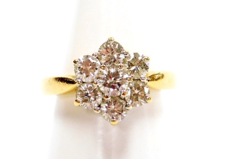 An 18ct gold and diamond flower head ring, of six petal form, each set with seven brilliant cut diamonds in a claw setting, approx 2ct, size M, 8.1g all in.