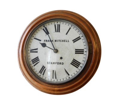 A mahogany bezel wall clock, with Roman numerals and marked FRANK MITCHELL STAMFORD, 42cm diameter. Please note this lot is located on site at the former offices of Messrs Stapleton & Son Solicitors, 1 Broad Street, Stamford, PE9 1PD. Viewing is by appo - 2