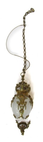 A brass hanging electrolier, the orb section with winged figures and shells, with a n opaque glass shade, 45cm high, with additional chain, and wall mount.