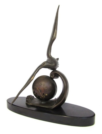 M Leducq. An Art Deco bronzed spelter mantel clock, with gilt over orb on an oval black marble base, 64cm high, 45cm wide, 16cm deep.