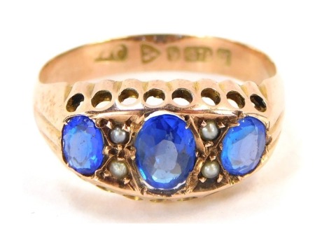 A 9ct gold gypsy ring, set with three oval dark blue stone, and seed pearls with pierced design borders, ring size O, 2.3g all in.