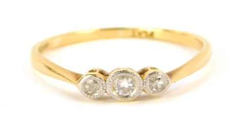 A three stone dress ring, set with three illusion set tiny diamonds, in platinum on a yellow metal band marked plat, ring size S 1.8g all in.