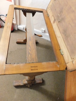 A Victorian oak architect's or library reading table, with lift top, that would rest on supports (AF), on a ratchet rise and fall mechanism, on chamfered supports with stretcher, 75cm minimum height, 92cm wide, 54cm deep. Please note this lot is located - 3