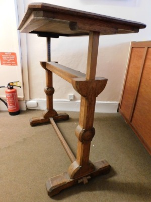 A Victorian oak architect's or library reading table, with lift top, that would rest on supports (AF), on a ratchet rise and fall mechanism, on chamfered supports with stretcher, 75cm minimum height, 92cm wide, 54cm deep. Please note this lot is located - 4