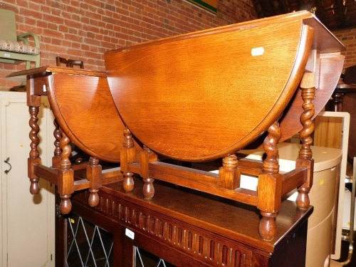 A pair of oak barley twist drop leaf occasional tables.