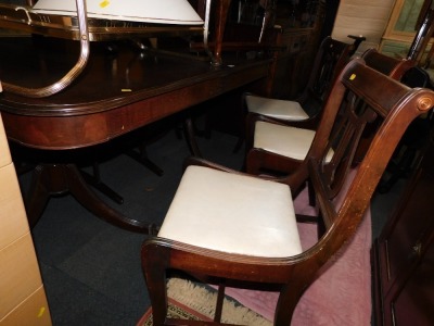 A reproduction mahogany twin pedestal dining table, with six lyre back chairs. (7) The upholstery in this lot does not comply with the 1988 (Fire & Fire Furnishing) Regulations, unless sold to a known exporter or upholsterer it will be cut from the frame