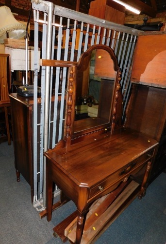 A mid 20thC Gibbard walnut three piece bedroom suite, comprising bed frame, dressing table and a chest of drawers. (3)