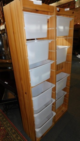 A pair of pine storage chests, with plastic drawers.