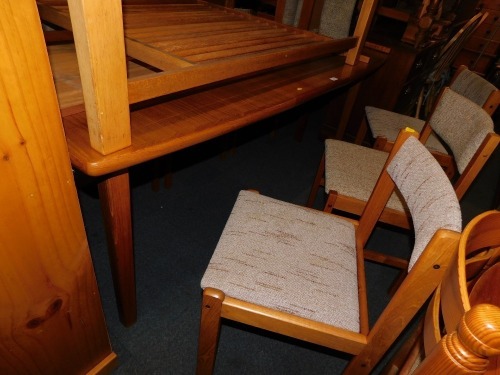 A late 20thC teak extending dining table, together with eight chairs. (9)