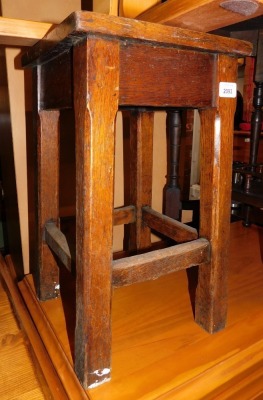 A late 19thC/early 20thC oak stool, with recessed top.